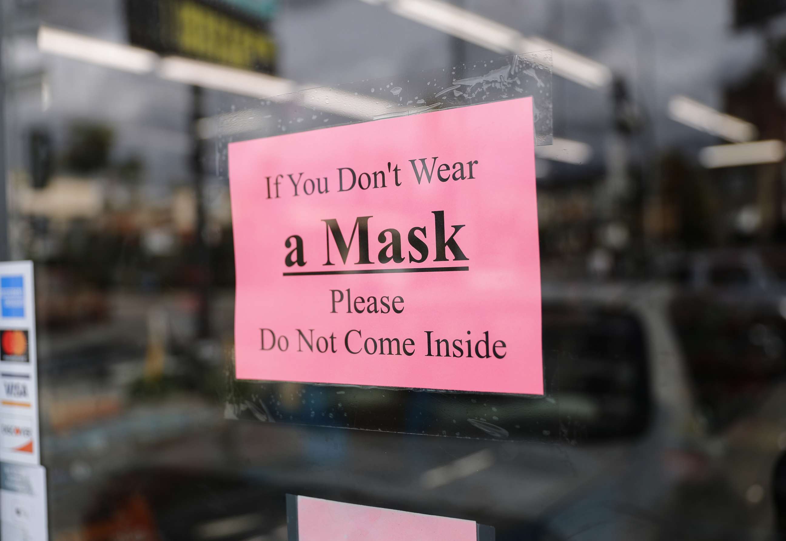 PHOTO: A sign reads "If You Don't Wear a Mask Please Do Not Come Inside" at a convenience store amid the coronavirus pandemic on April 8, 2020 in Los Angeles, California. 