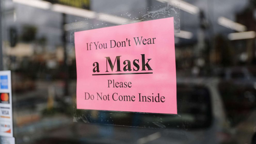 PHOTO: A sign reads "If You Don't Wear a Mask Please Do Not Come Inside" at a convenience store amid the coronavirus pandemic on April 8, 2020 in Los Angeles, California. 