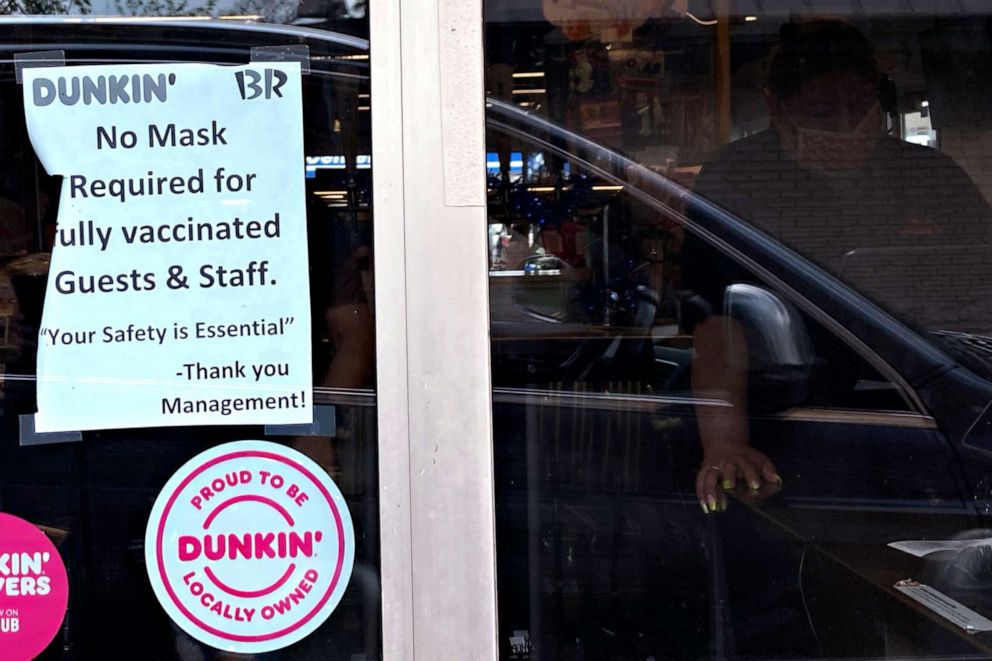 PHOTO: 	A mask information sign is displayed at a Dunkin' store in Arlington Heights, Ill., June 30, 2021.