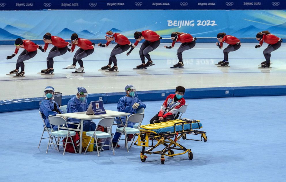 PHOTO: Medical staff sit at a table as Norwegian speed skaters take part in a practice session at the National Speed Skating Oval, Jan. 29, 2022, in Beijing.