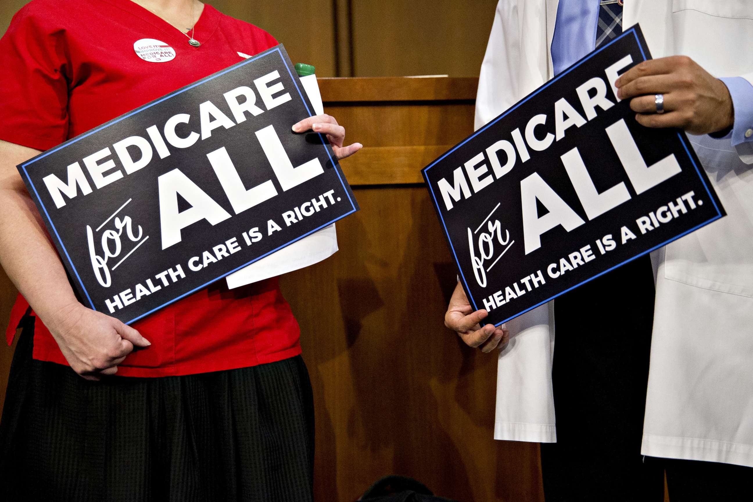 PHOTO: Attendees hold signs while waiting for a health care bill news conference to begin on Capitol Hill in Washington, Sept. 13, 2017.