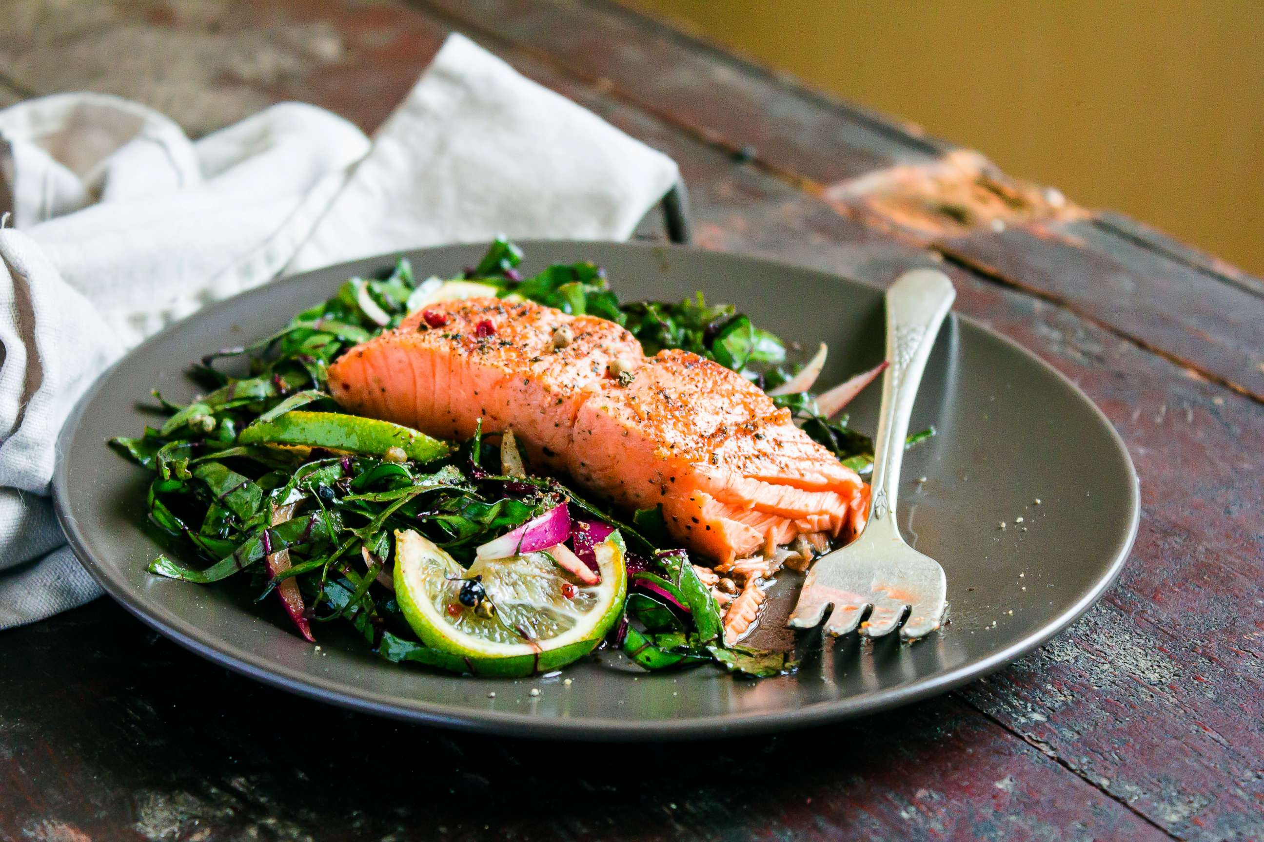 PHOTO: A filet of salmon is served over a bed of greens in this stock photo.