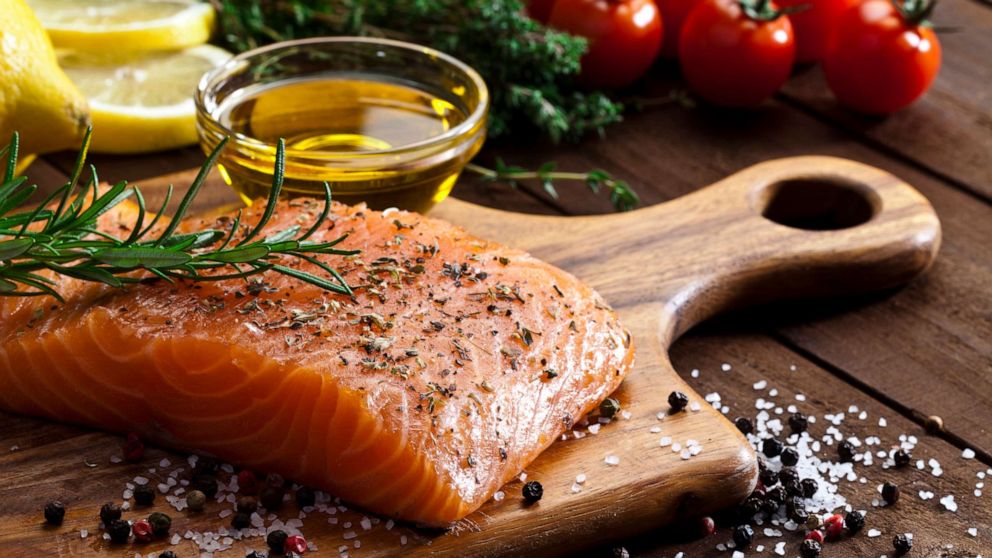 PHOTO: Seasoned salmon and olive oil are prepared in this stock photo.