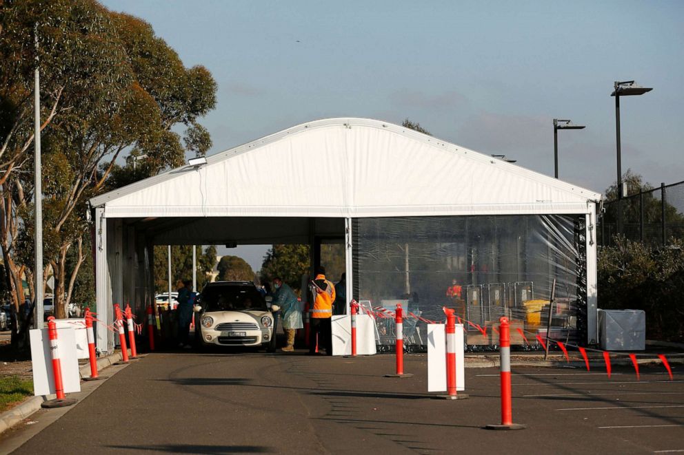 PHOTO: Cars enter a drive-through COVID-19 testing facility in Hoppers Crossing, Melbourne, Australia, July 17, 2020.