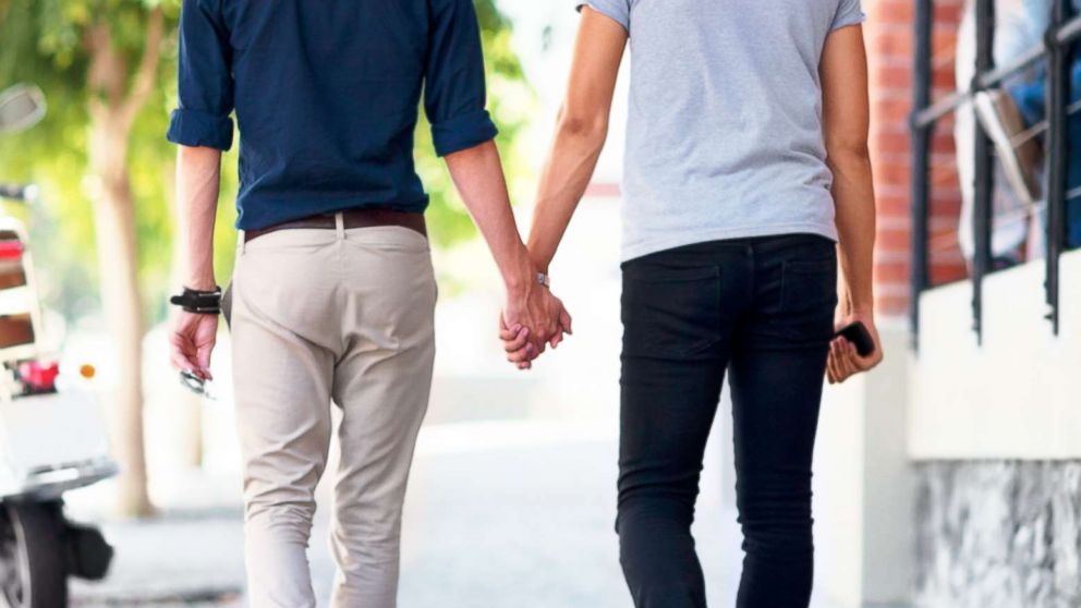 PHOTO: Two men hold hands while walking down a sidewalk in an undated stock photo.