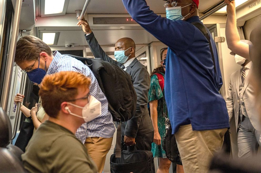 PHOTO: Commuters wearing masks travel on the Metro on April 14, 2022 in Washington, D.C.