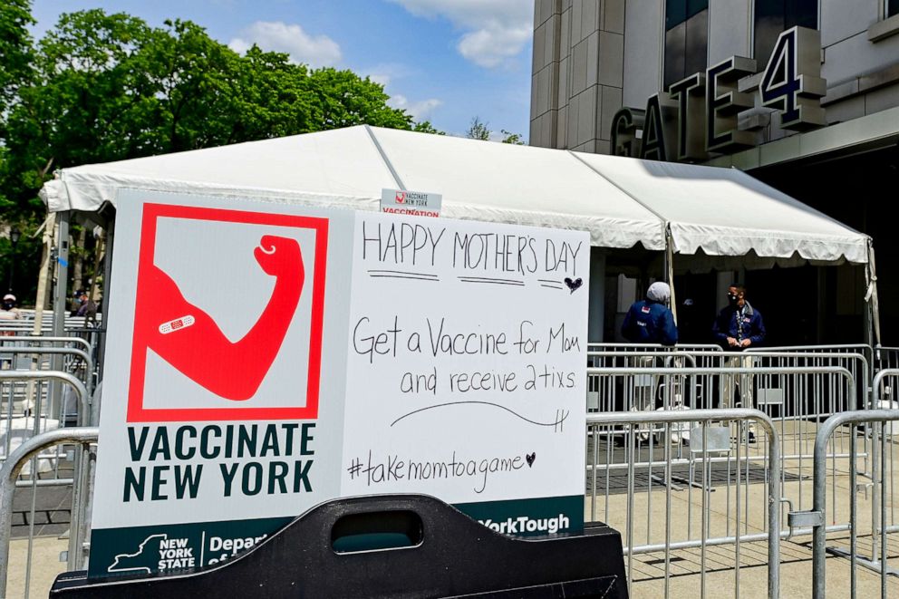 PHOTO: A sign offers fans free tickets to a future game if they receive a Covid-19 vaccine offered at the stadium prior to the game on May 9, 2021 in the Bronx borough of New York City.