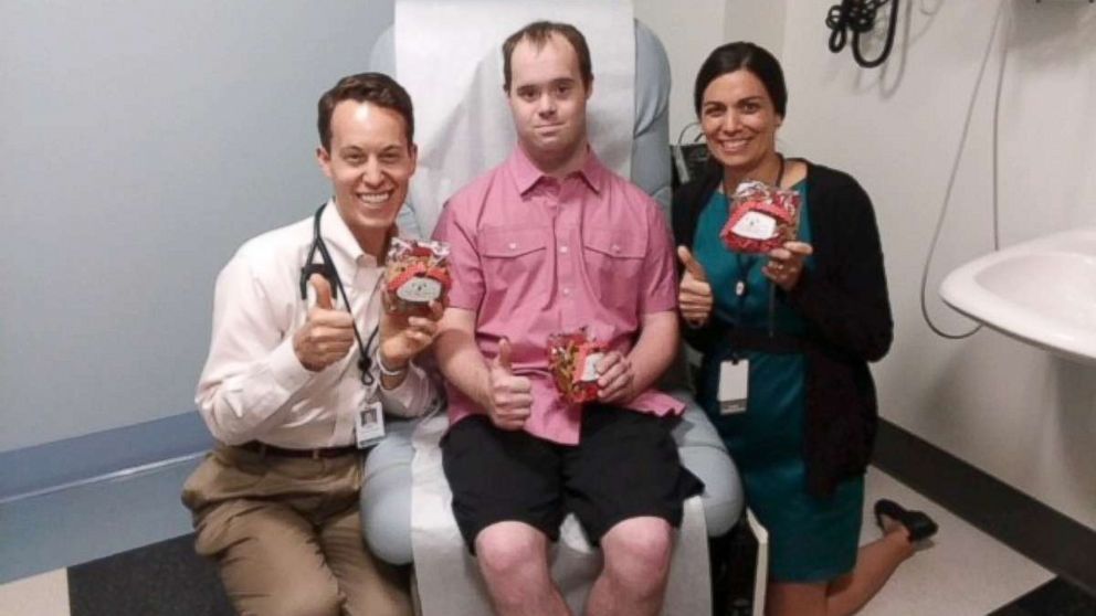 PHOTO: Michael Clayburgh, center, poses with Dr. Brian Skotko, left, and Amy Torres at Massachusetts General Hospital in Boston.