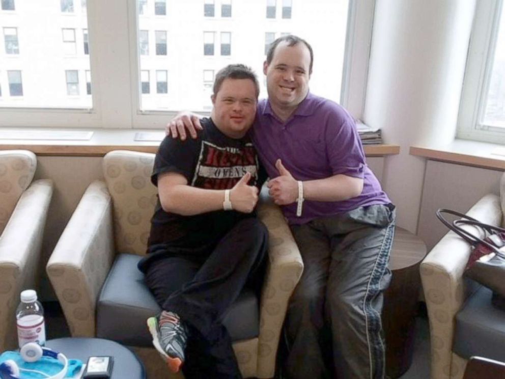 PHOTO: Michael Claybrugh, 29, right, poses with a fellow trial participant at Massachusetts General Hospital in Boston.
