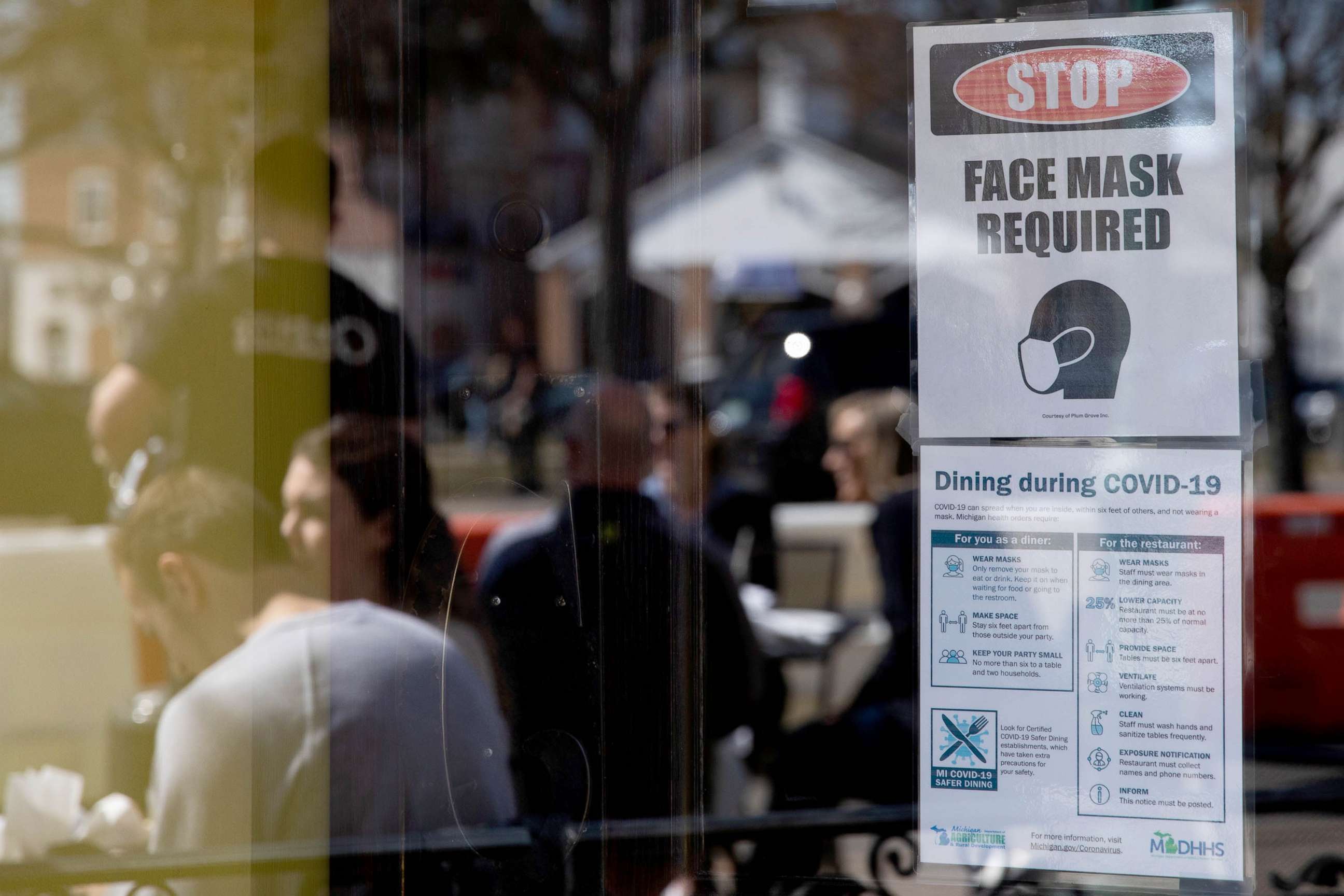 PHOTO: A sign requiring face masks and Covid-19 protocols at a restaurant in Plymouth, Mich., March 21, 2021. 