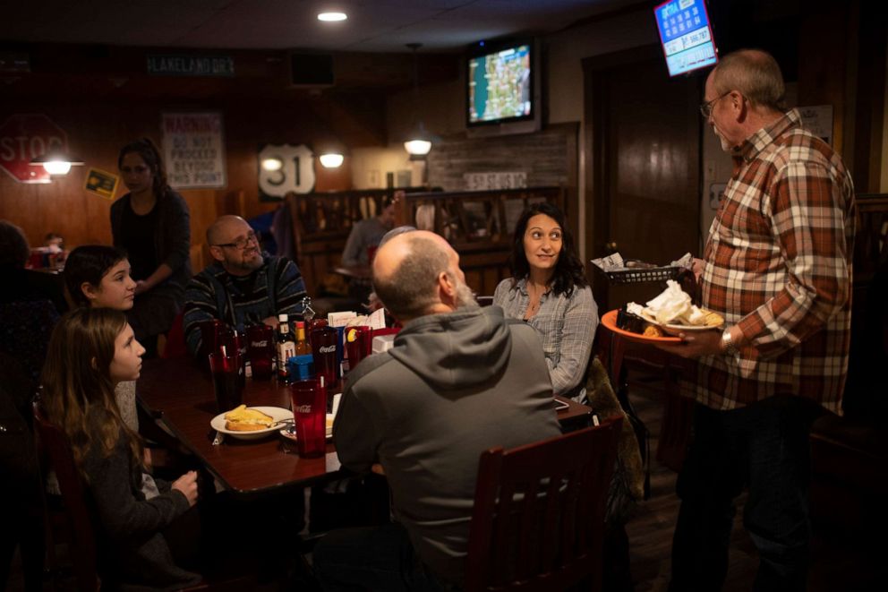 PHOTO: In this Jan. 18, 2021, file photo, Jim Cory, the owner of Jimmys Roadhouse converses with his customers at his restaurant in Newaygo, Mich.