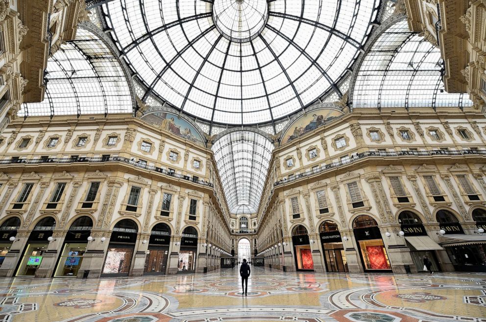 PHOTO: A person stands inside a deserted Galleria Vittorio Emanuele II, on the third day of an unprecedented lockdown across of all Italy imposed to slow the outbreak of coronavirus, in Milan, Italy, March 12, 2020. 