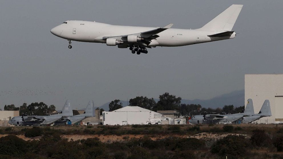 PHOTO: A plane carrying evacuees from the virus zone in China lands at Marine Corps Air Station Miramar, Feb. 5, 2020, in San Diego. 