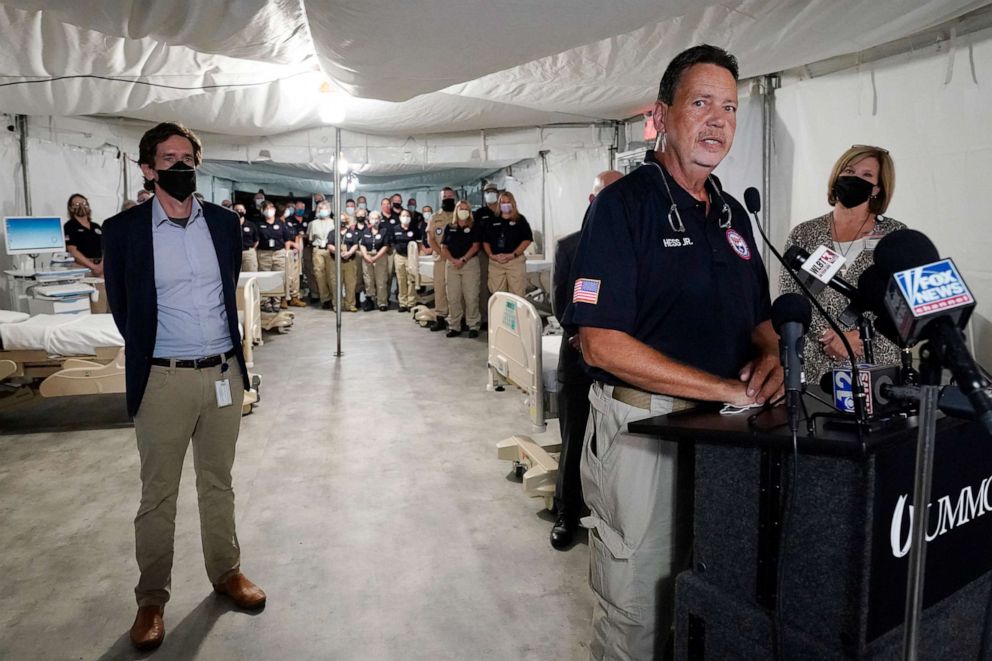 PHOTO: Cmdr. Richard Hess Jr., center, with the National Disaster Medical System, speaks to how he and his team will help staff the field hospital in a garage at the University of Mississippi Medical Center in Jackson, Miss., Thursday, Aug. 12, 2021.