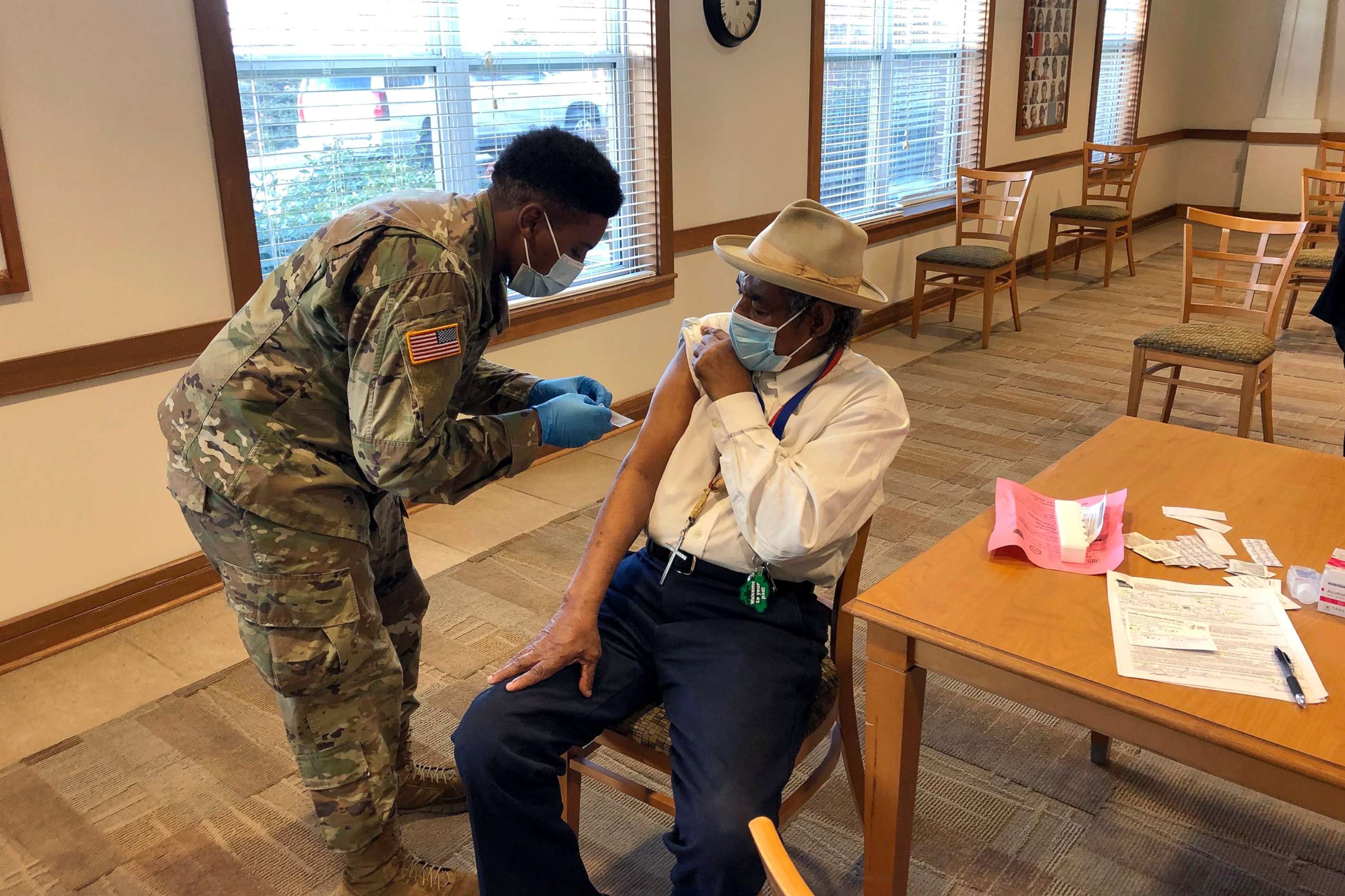PHOTO: The Rev. Oliver Savage gets a COVID-19 vaccine from Missouri National Guard member Richard Waithira, March 4, 2021, during a vaccination clinic at a St. Louis senior center.