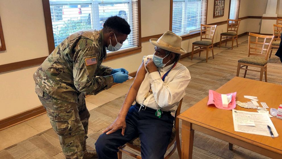 PHOTO: The Rev. Oliver Savage gets a COVID-19 vaccine from Missouri National Guard member Richard Waithira, March 4, 2021, during a vaccination clinic at a St. Louis senior center.