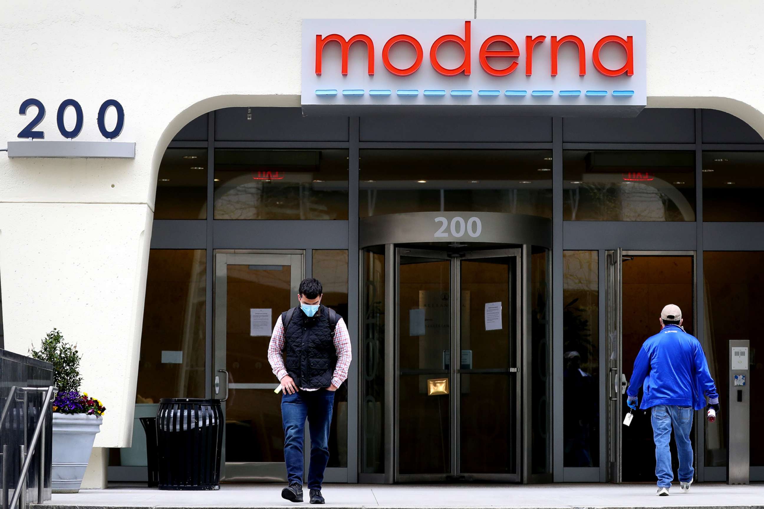 PHOTO: People come and go outside Moderna headquarters in Cambridge, Mass., May 8, 2020.