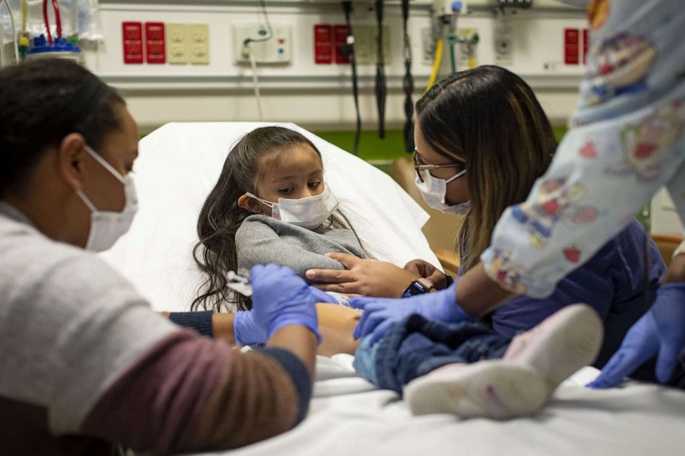 PHOTO: A 3 year old girl receives a dose of the Moderna Covid-19 vaccine as she participates in a trial in Chicago, Dec. 7, 2021.