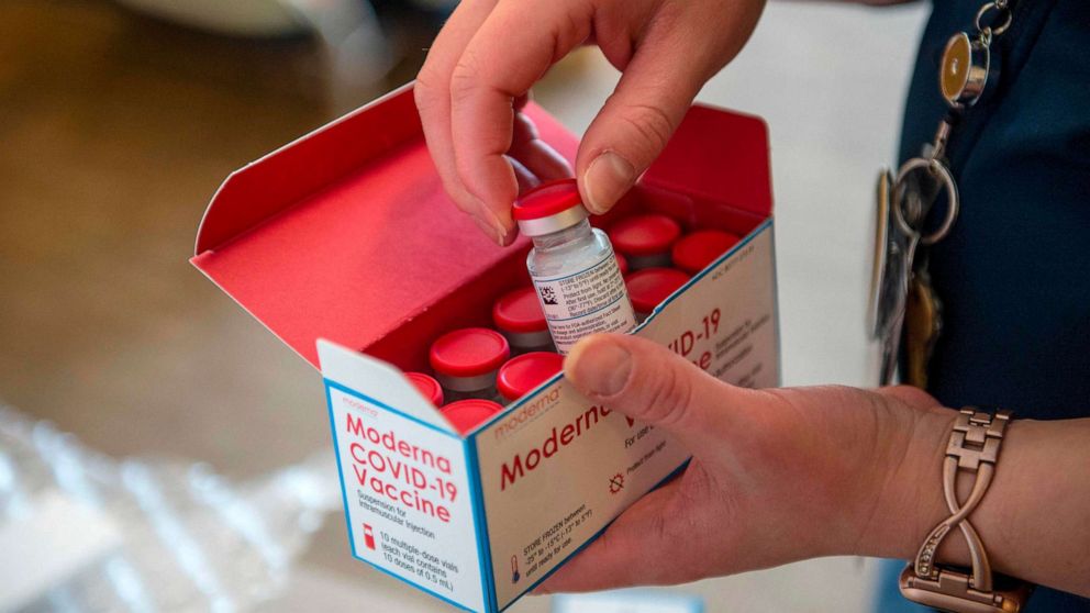 PHOTO: Nurse Courtney Senechal unpacks a special refrigerated box of Moderna COVID-19 vaccines as she prepared to ready more supply for use at the East Boston Neighborhood Health Center in Boston, on Dec. 24, 2020.