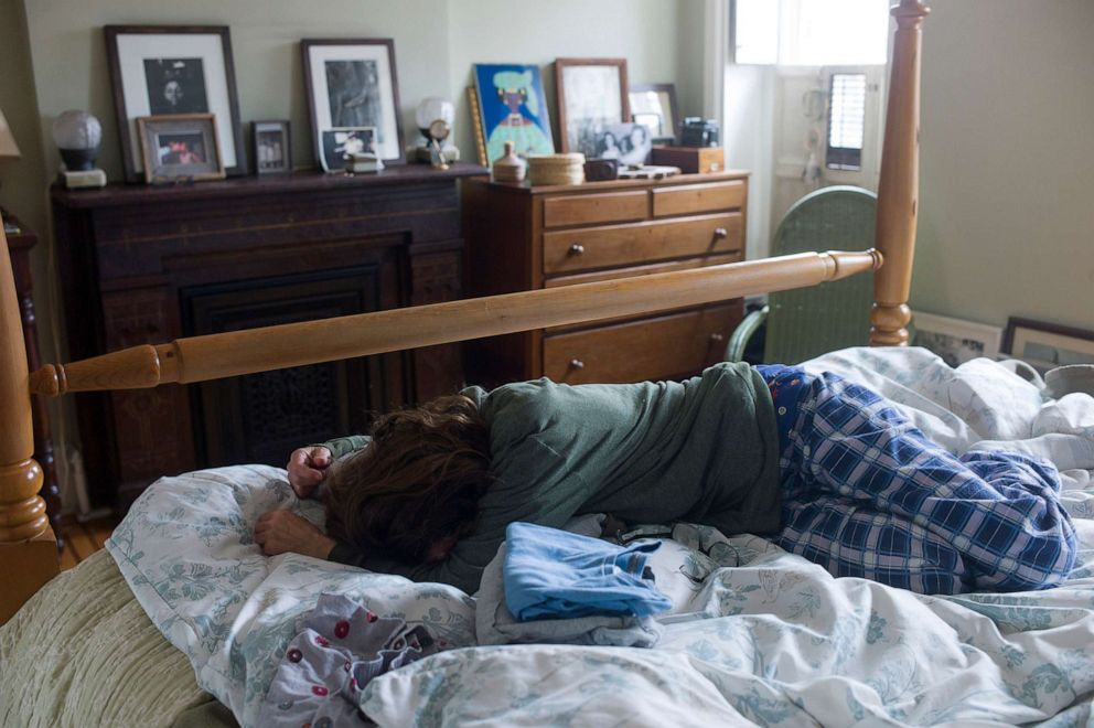 PHOTO: A mother struggles to get out of bed in the morning after continuous news of a pandemic, isolation at home, and school being cancelled for her two children on March 17, 2020 in New York City's borough of Brooklyn, N.Y.