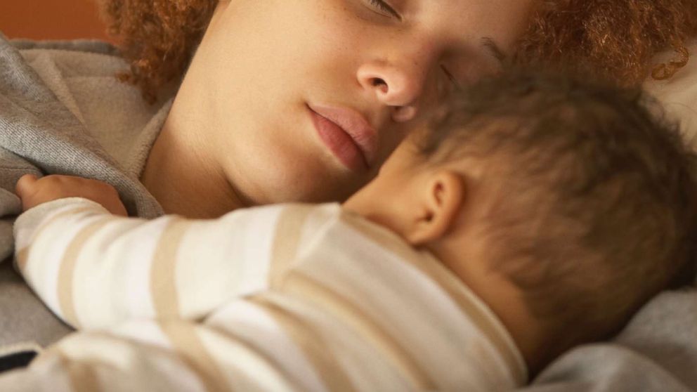 PHOTO: A mother sleeps with her newborn baby in an undated stock photo. 