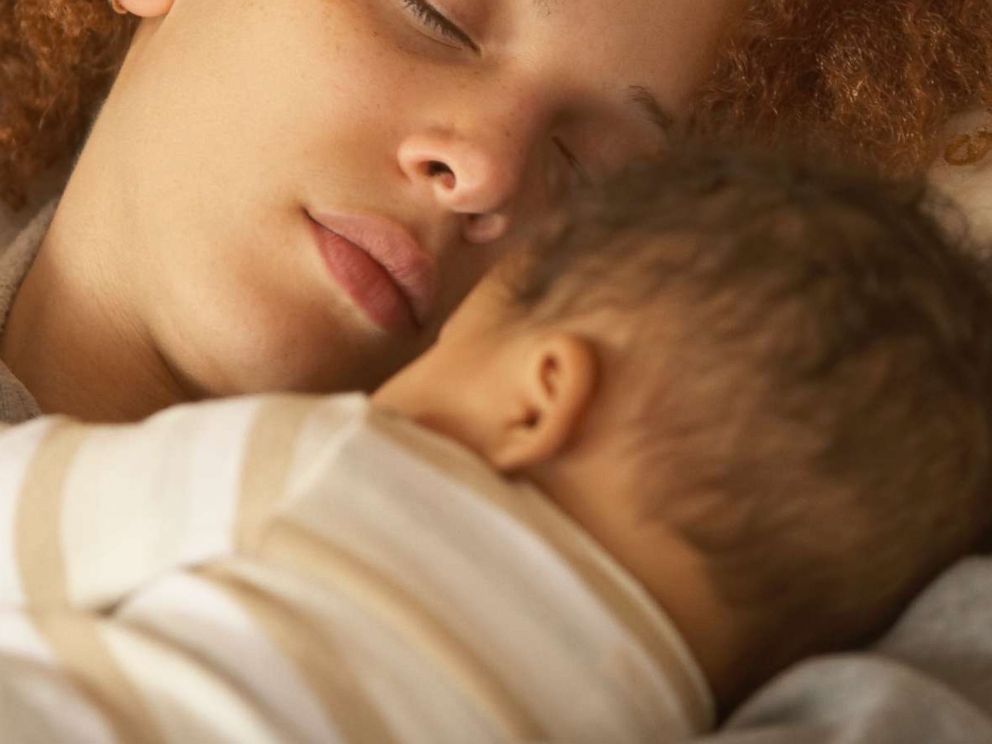 PHOTO: A mother sleeps with her newborn baby in an undated stock photo.