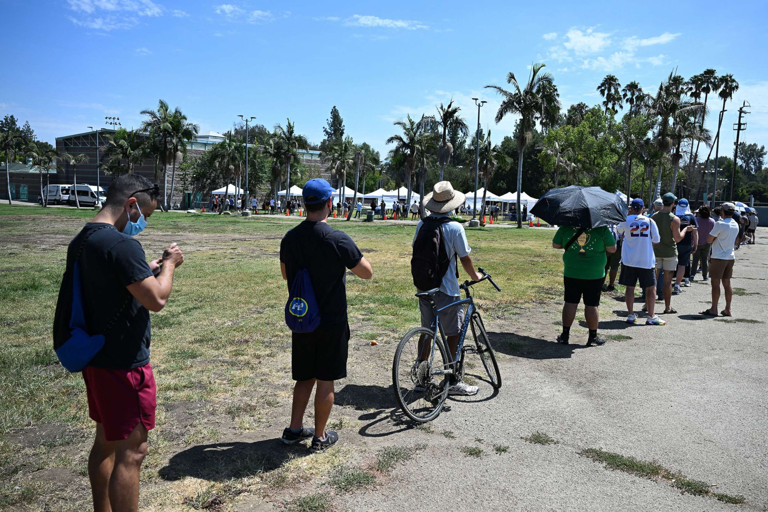 PHOTO: People wait in line for the monkeypox vaccine at the Balboa Sports Center in the Encino neighborhood of Los Angeles, July 27, 2022. 