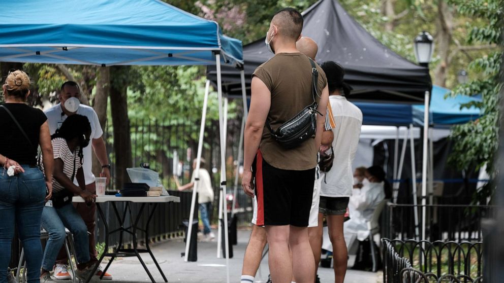 PHOTO: People line up to speak with healthcare workers with New York City Department of Health and Mental Hygiene at intake tents where individuals register to receive the monkeypox vaccine, Aug. 5, 2022 in New York City.