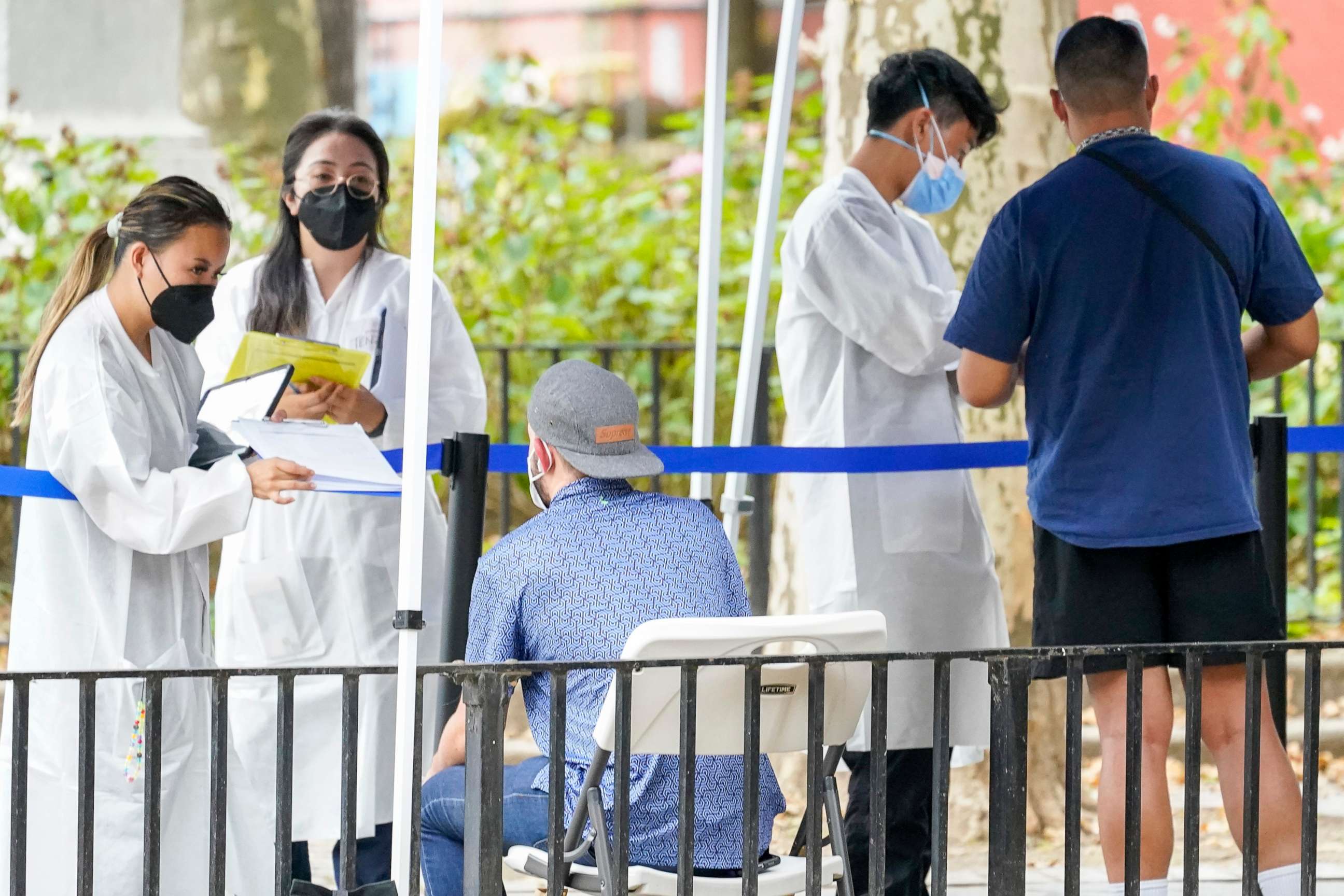 PHOTO: Healthcare workers with New York City Department of Health and Mental Hygiene help people register for the monkeypox vaccine at one of the City's vaccination sites, on July 26, 2022, in New York.