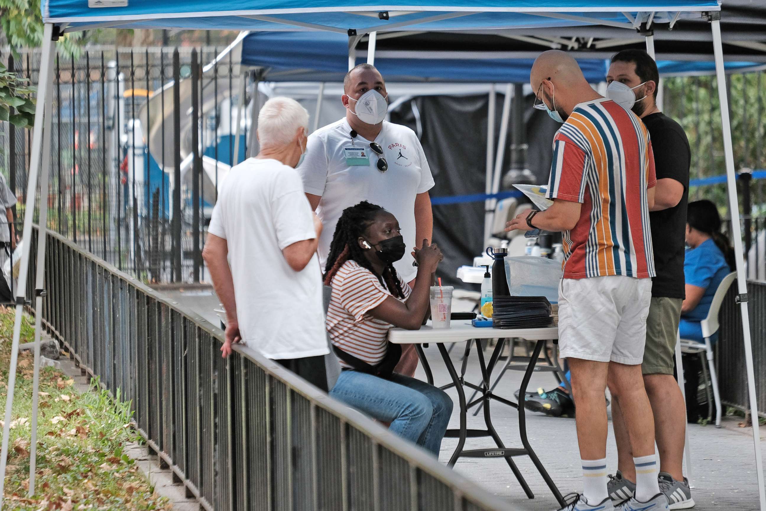 PHOTO: People line up to speak with healthcare workers at intake tents where individuals  register to receive the monkeypox vaccine on Aug. 5, 2022 in New York City. 