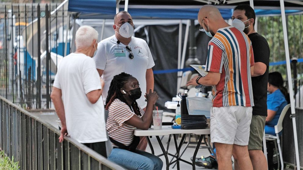 PHOTO: People line up to speak with healthcare workers at intake tents where individuals  register to receive the monkeypox vaccine on Aug. 5, 2022 in New York City. 