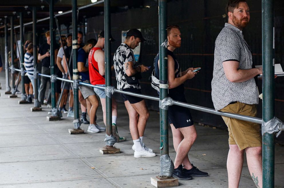 PHOTO: People wait in line to receive the monkeypox vaccine before the opening of a new mass vaccination site at the Bushwick Education Campus in Brooklyn on July 17, 2022, in New York.