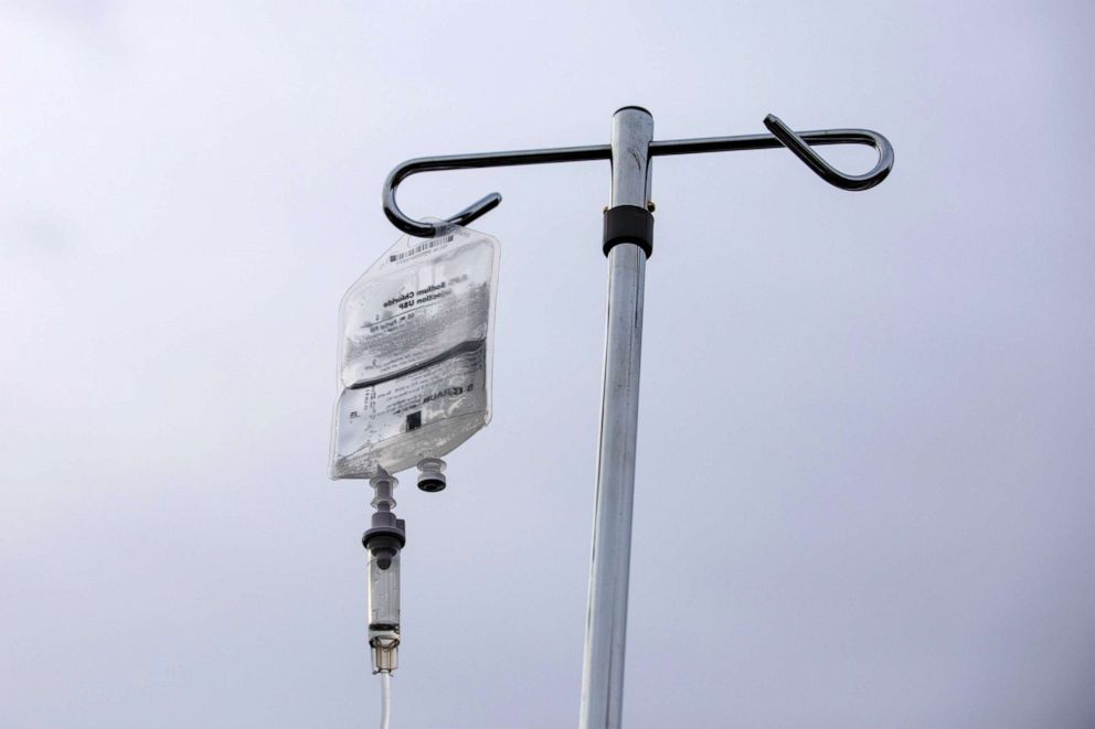 PHOTO: In this Dec. 23, 2021, file photo, a monoclonal antibody treatment on an IV pole is shown in the parking lot at Wayne Health Detroit Mack Health Center in Detroit, Mich.