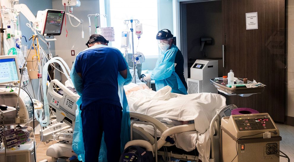 PHOTO: Shannon Stewart, right,  a respiratory therapist at downtown campus of NCH in Naples treats a COVID-19 patient with a fellow ICU colleague in the ICU, Naples, Fla., Aug. 9, 2021.