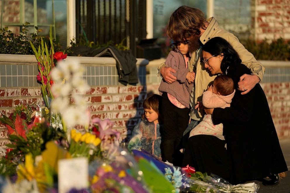 PHOTO: A family gathers at a memorial outside the Star Ballroom Dance Studio, Jan. 24, 2023, in Monterey Park, Calif.