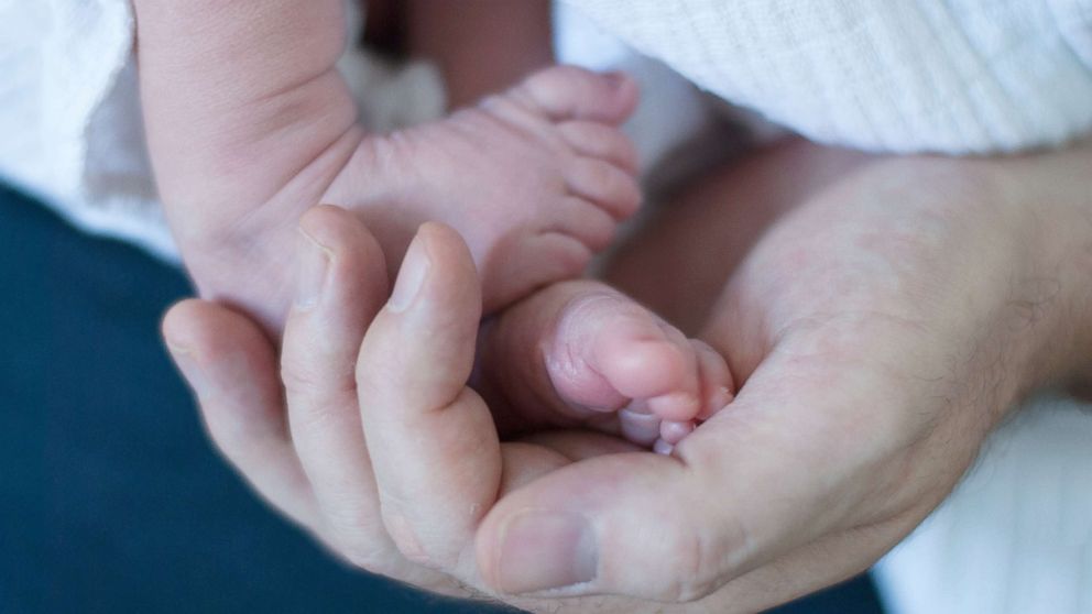 PHOTO: An adult holds a newborn's feet in an undated stock photo.