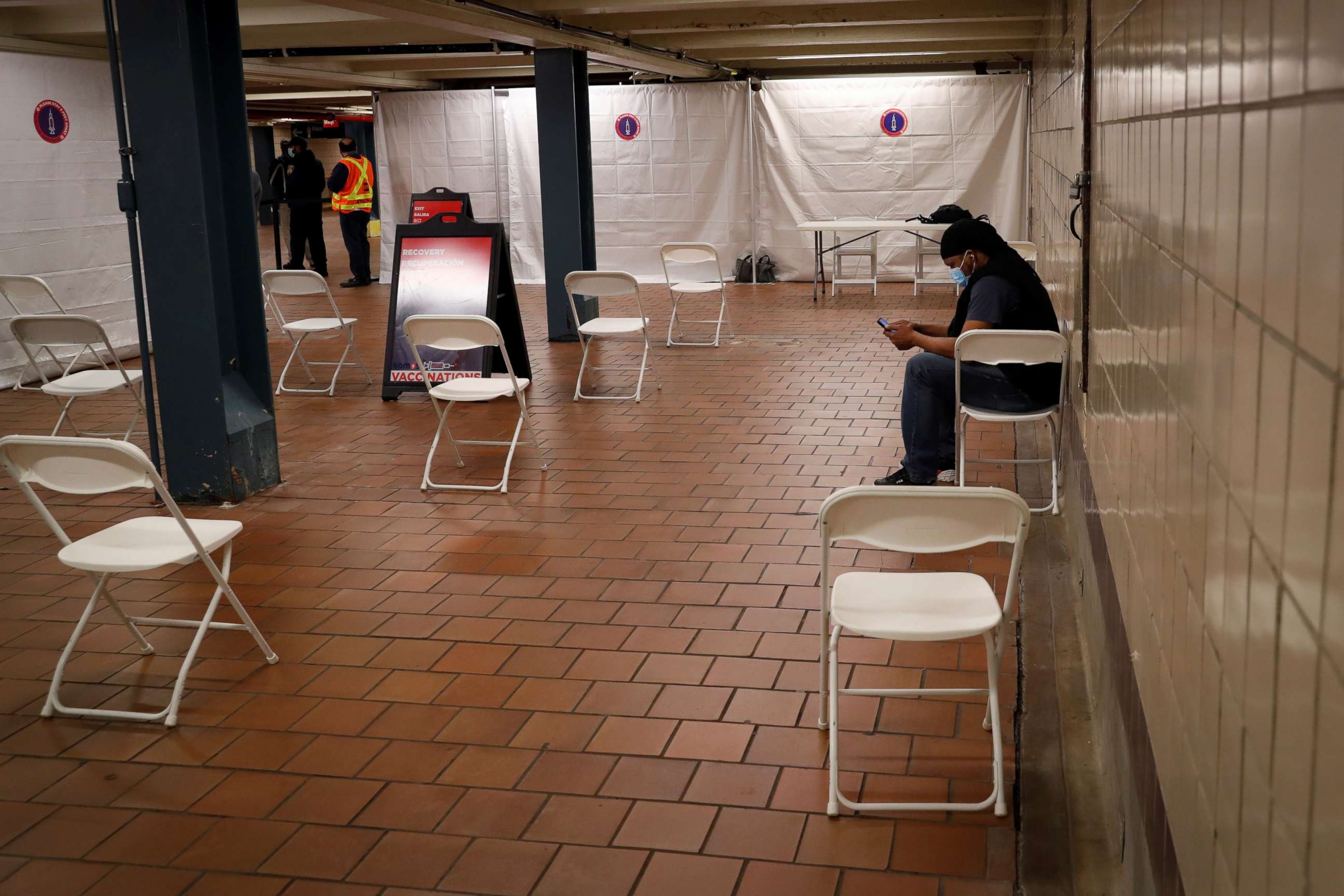 PHOTO: Commuter Garnett Ricketts waits the mandatory 15 minutes after receiving the Johnson & Johnson vaccine during the opening of MTA's public vaccination program at the 179th Street subway station in Queens, New York City, May 12, 2021.