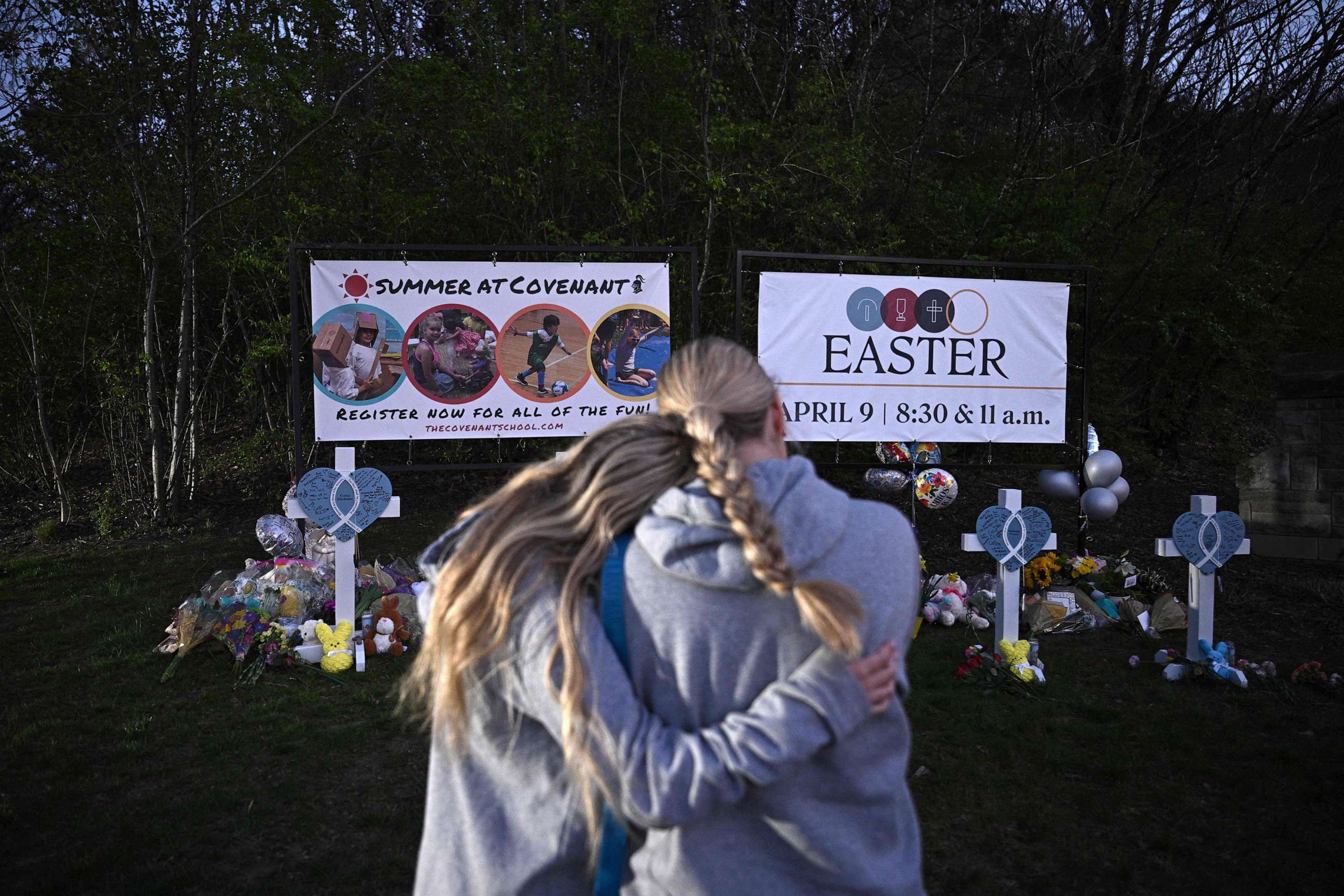 PHOTO: People embrace at a makeshift memorial for victims of a shooting at the Covenant School campus, in Nashville, Tenn., March 28, 2023.