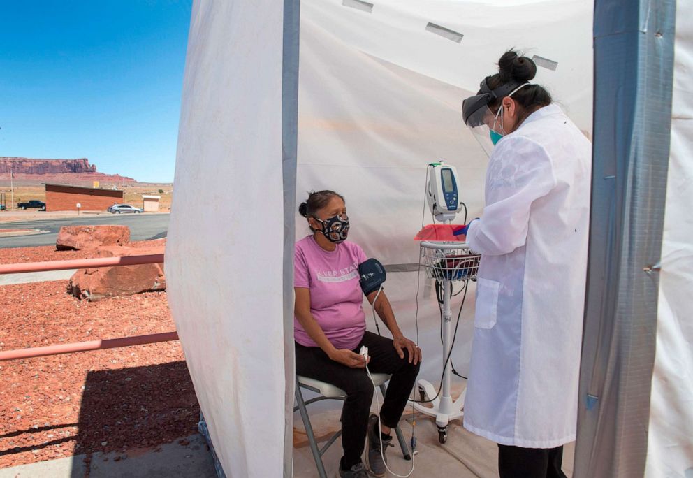 PHOTO: A nurse checks vitals from a Navajo Indian woman complaining of virus symptoms, at a COVID-19 testing center at the Navajo Nation town of Monument Valley in Ariz., May 21, 2020.