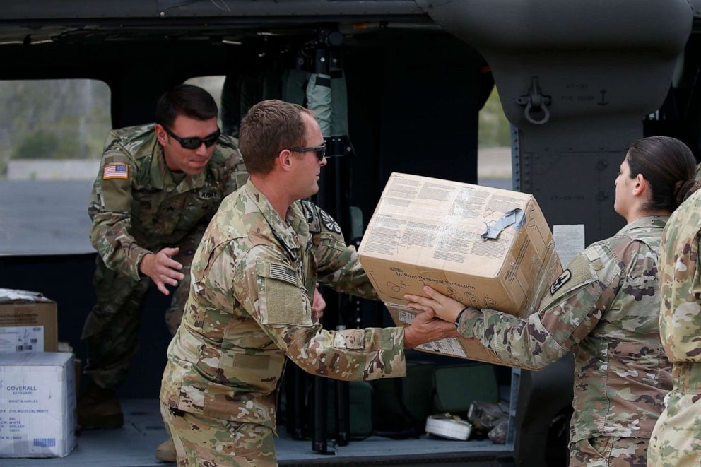 PHOTO: Members of an Arizona National Guard unit load medical supplies into a helicopter for delivery to the remote Navajo Nation town of Kayenta, hit hard by the coronavirus, to build a temporary hospital and resupply clinics, March 31, 2020, in Phoenix.