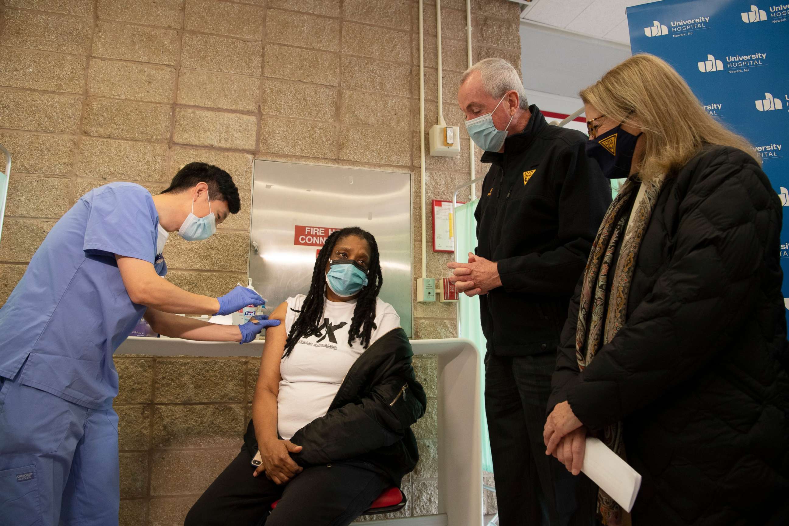 PHOTO: A registered nurse administers a Modera booster vaccine to Newark resident Sylvia Lee in front of New Jersey Governor Phil Murphy and NJ Health Commissioner Judith Persichilli, Dec. 15, 2021.