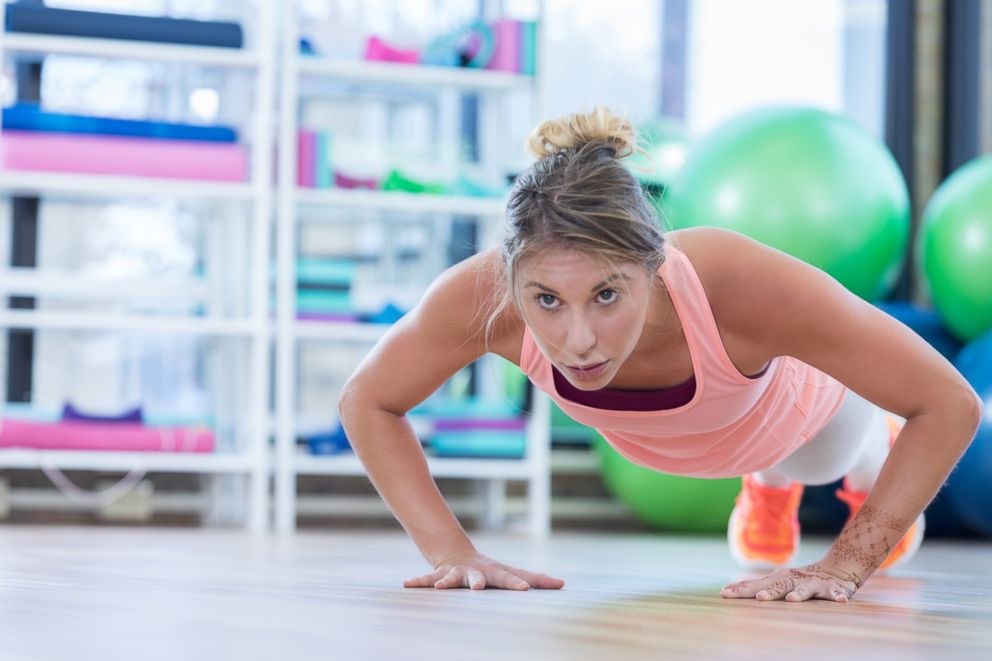 PHOTO: A woman does push ups while working out in a gym in this stock image. 