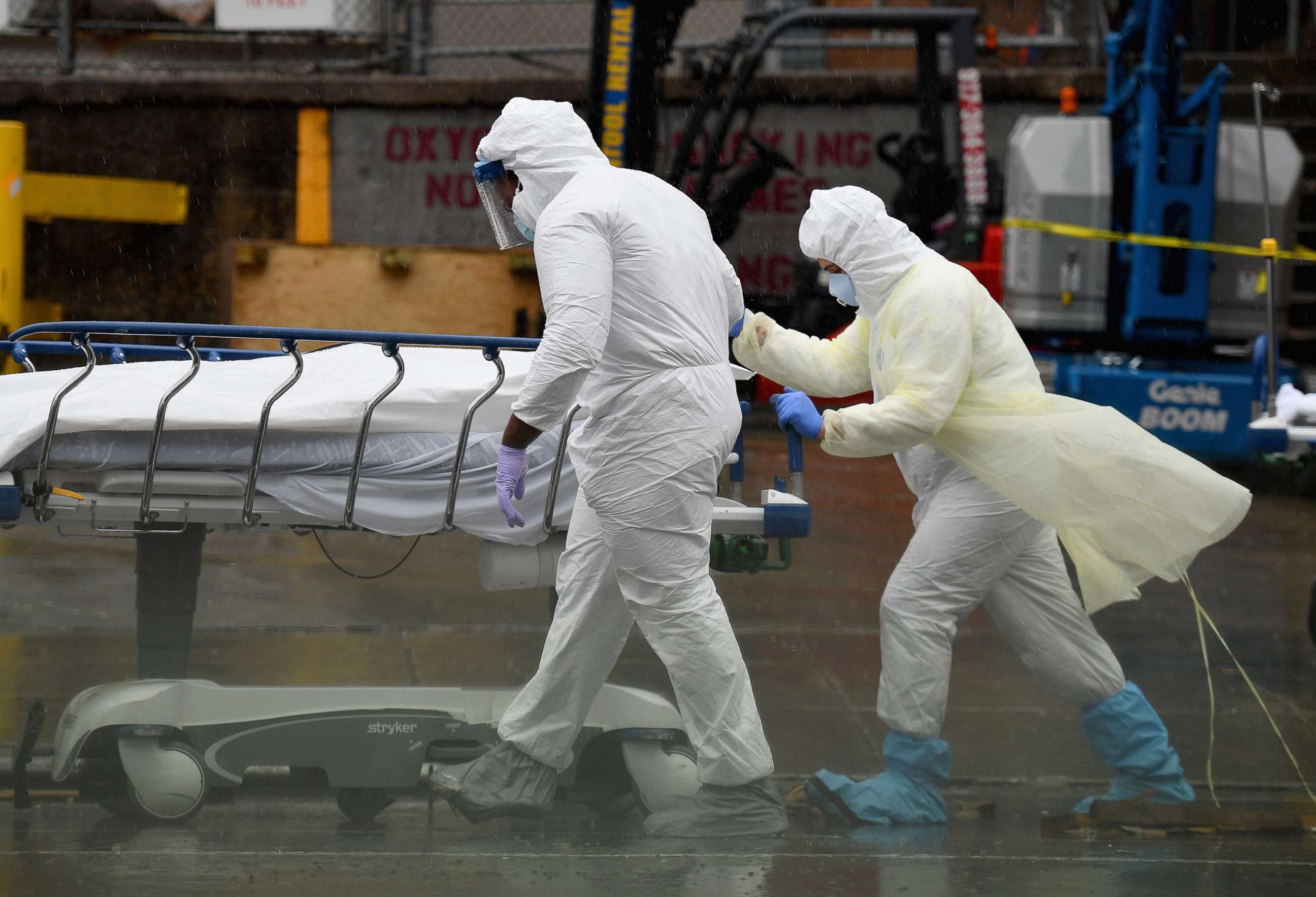 PHOTO: In this April 9, 2020, file photo, medical personnel move a deceased patient to a refrigerated truck serving as make shift morgues at Brooklyn Hospital Center in New York.