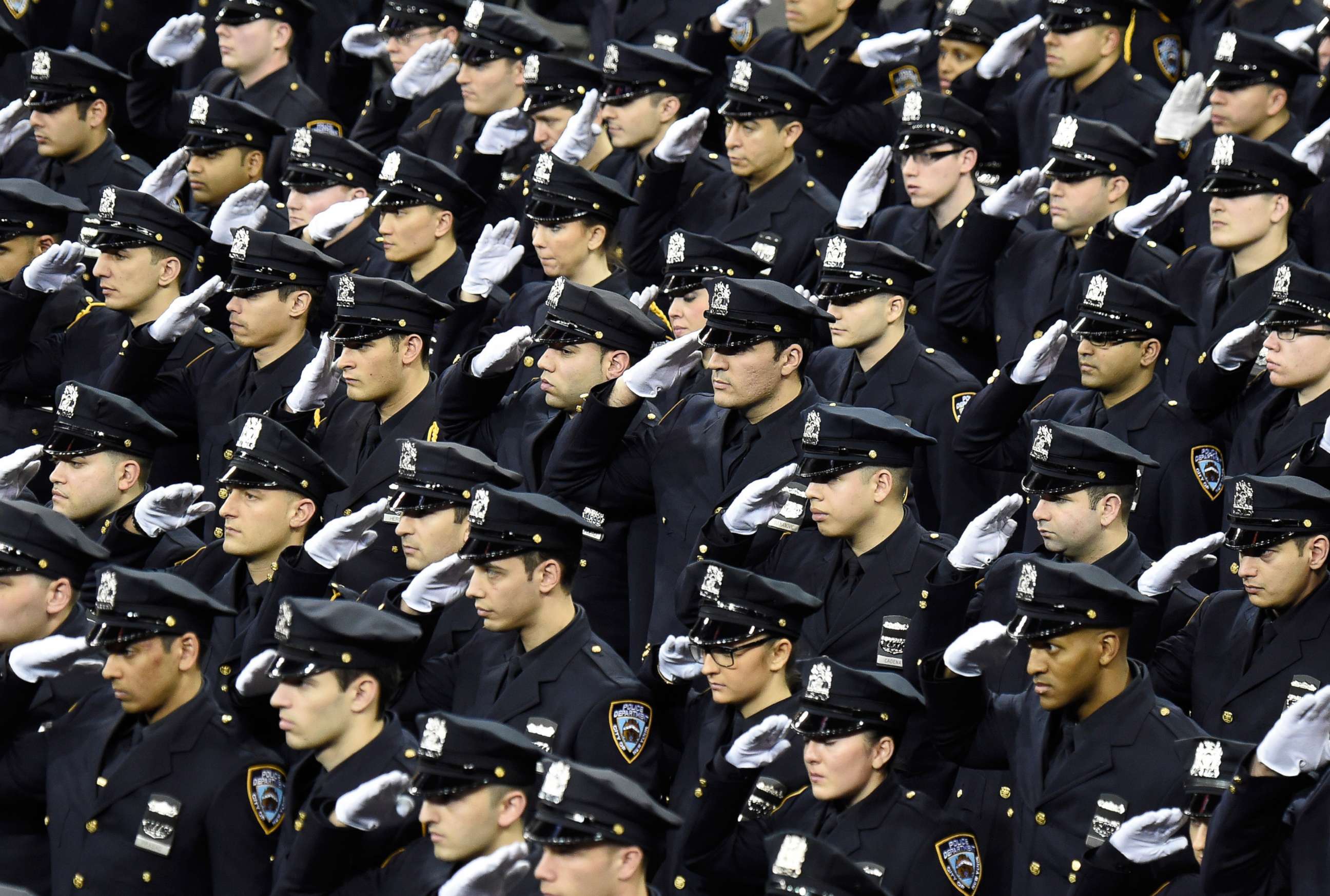 PHOTO: Cadets salute during the New York Police Department graduation ceremony at Madison Square Garden on Dec. 29, 2014, in New York.