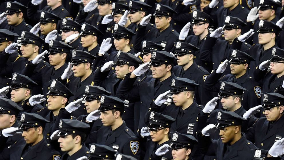 PHOTO: Cadets salute during the New York Police Department graduation ceremony at Madison Square Garden on Dec. 29, 2014, in New York.