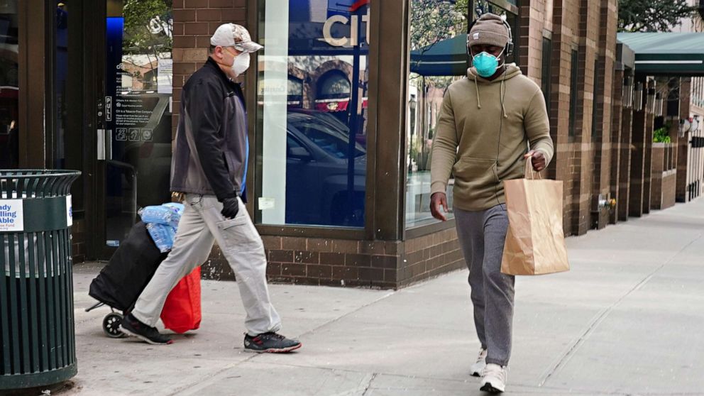 PHOTO: Men walking wearing protective masks during the coronavirus pandemic on April 08, 2020, in New York.