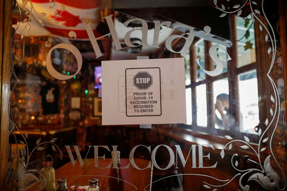 PHOTO: Signage is seen in the entrance of O'Hara's, a bar near the World Trade Center, as the vaccine mandate began in New York, Aug. 17, 2021.