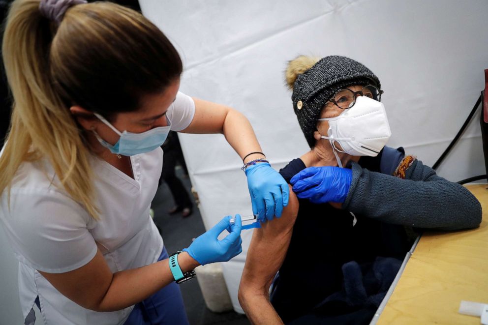 PHOTO: A healthcare worker administers a shot of the Moderna COVID-19 Vaccine to a woman at a pop-up vaccination site operated by SOMOS Community Care during the coronavirus disease  pandemic in New York, Jan. 29, 2021.