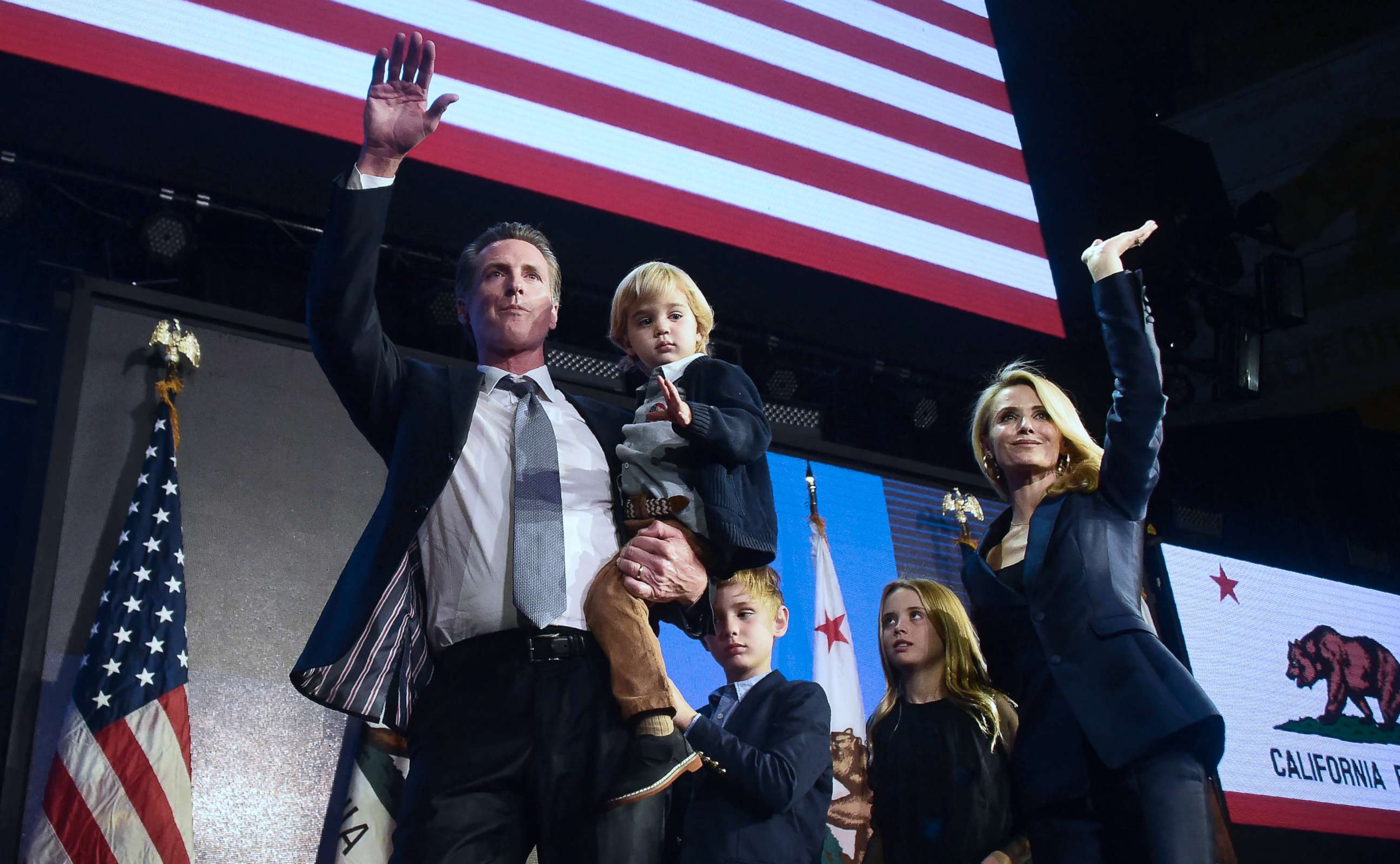 PHOTO: California's Democratic gubernatorial candidate Gavin Newsom and his family wave to supporters from the stage at his election night watch party in Los Angeles, Nov, 6, 2018.
