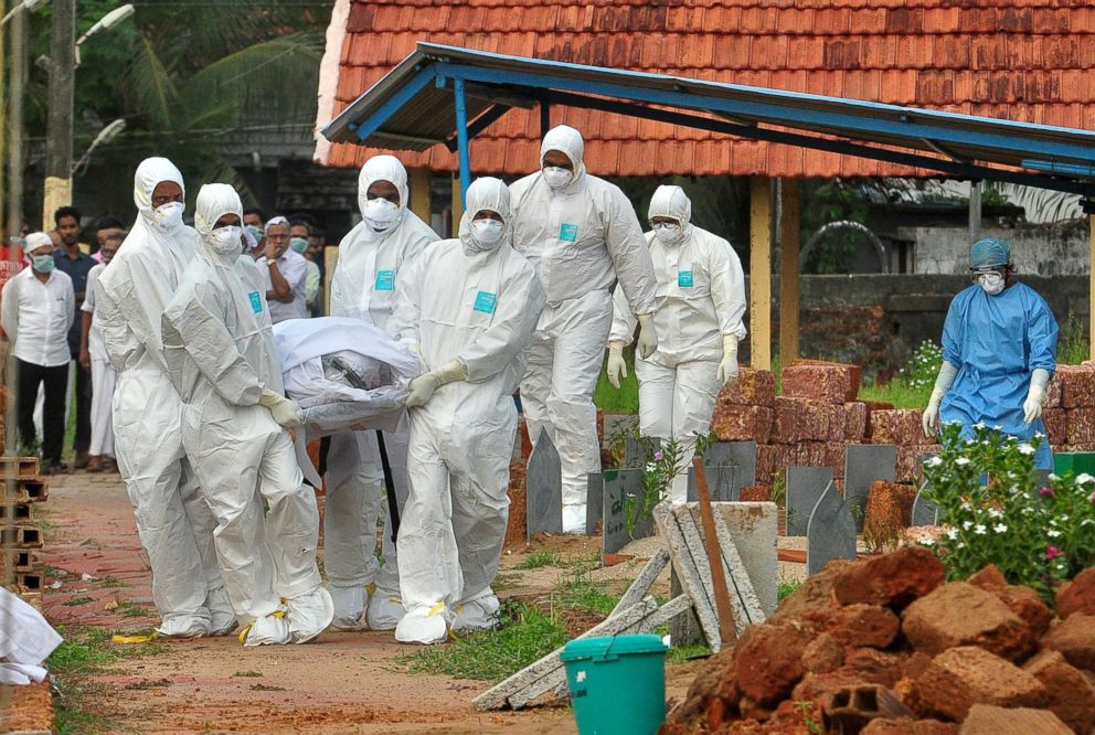 PHOTO: Doctors and relatives wearing protective gear carry the body of a victim, who lost his battle against the brain-damaging Nipah virus, during his funeral at a burial ground in Kozhikode, in the southern Indian state of Kerala, India, May 24, 2018.
